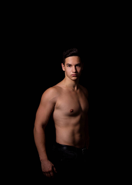 muscular guy on a black background. studio photo - 写真・画像