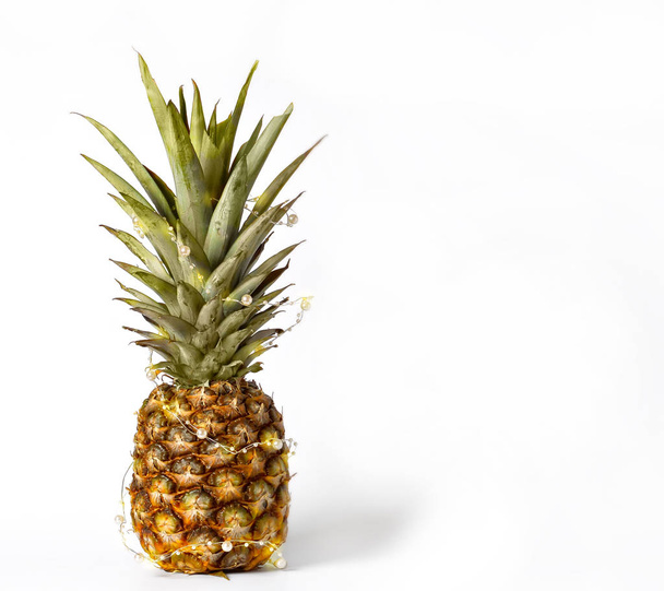 Pineapple garland decorated for holiday, party, christmas. Copy space. - Valokuva, kuva