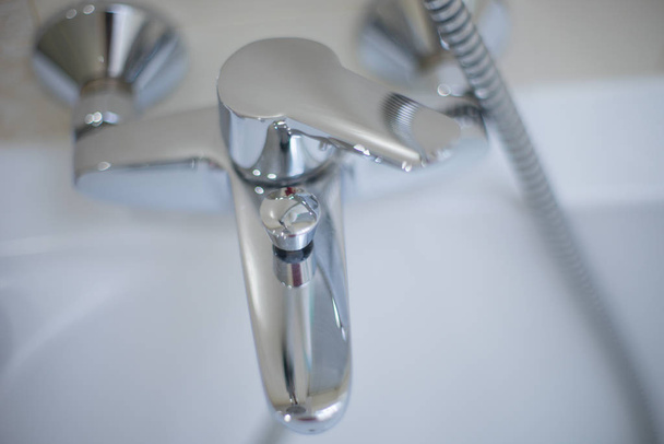 Chrome water tap, top view. Shiny faucet closeup. - 写真・画像