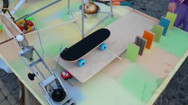 Rube Goldberg Machine.A few spells fall, freeing the skateboard, which pulls the rope and launches the ball through the gutter - Footage, Video