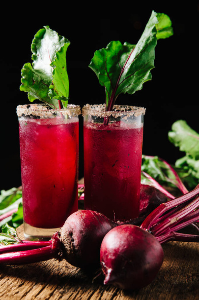 Red beet juice in tall glasses on rustic background  - Photo, Image