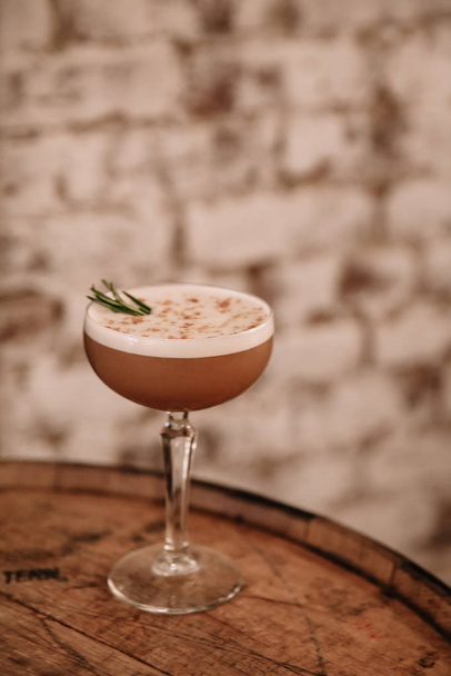 Creamy coffee cocktail garnished with rosemary  - Foto, Imagem