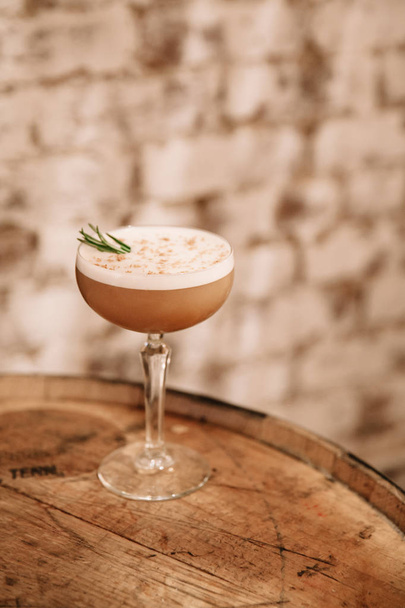 Creamy coffee cocktail garnished with rosemary  - Photo, Image