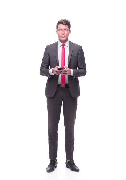 in full growth. young businessman with a smartphone. - Foto, Bild