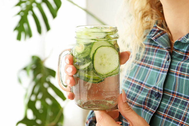 Woman with mason jar of healthy infused water at home - Photo, Image
