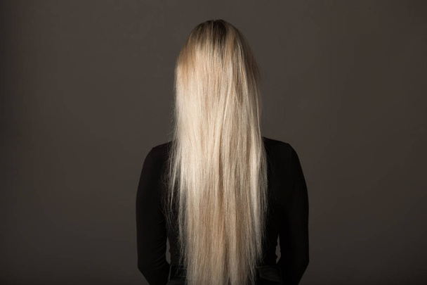 young woman with long white hair on a black background - Foto, Imagen