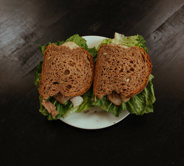 Sandwich with Hum and salad on black table - Foto, Bild