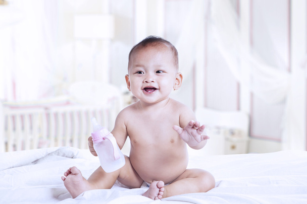 Baby with a milk bottle - Фото, зображення
