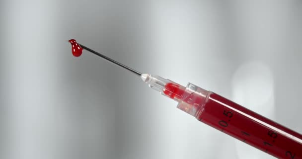 Syringe filled with blood and dripping from the needle - Footage, Video