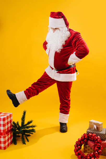Cheerful Santa Claus in a funny pose, studio shot.  - Fotoğraf, Görsel