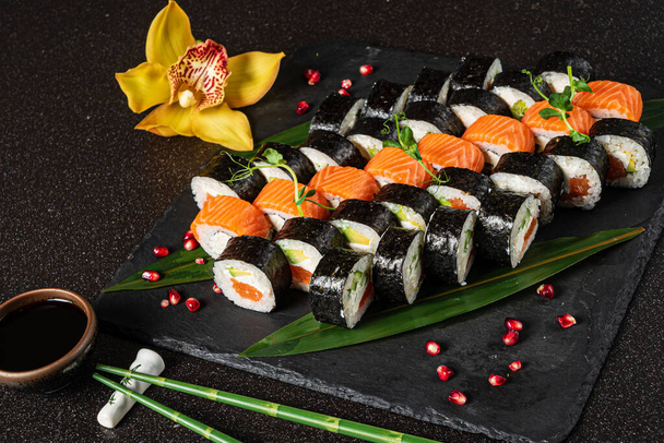tasty sushi on the black background - Фото, изображение