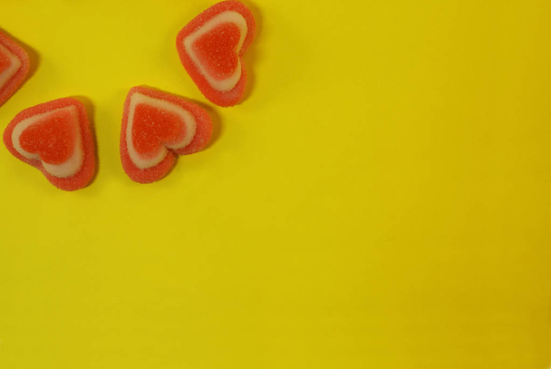 Marmalade sweets in sugar and in the form of a heart on a bright background. - Photo, image