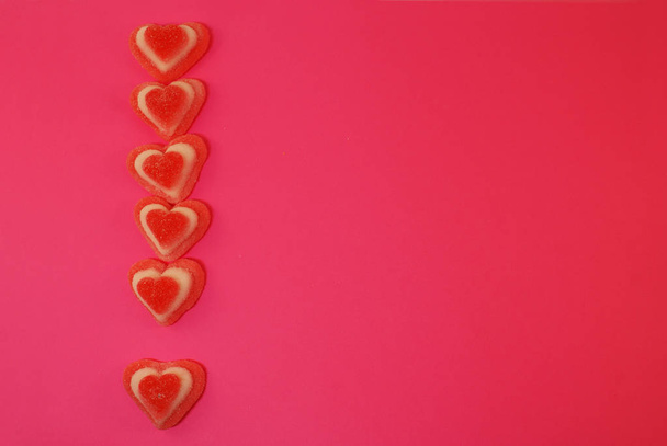 Γλυκά μαρμελάδας σε ζάχαρη και σε σχήμα καρδιάς σε φωτεινό φόντο. - Φωτογραφία, εικόνα