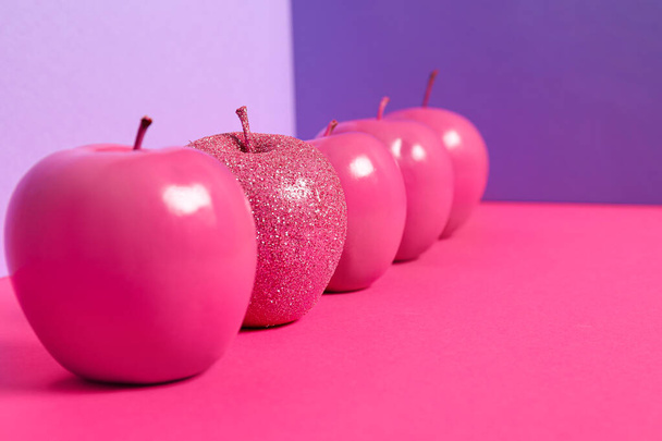 Apples on color background. Concept of uniqueness - Фото, изображение
