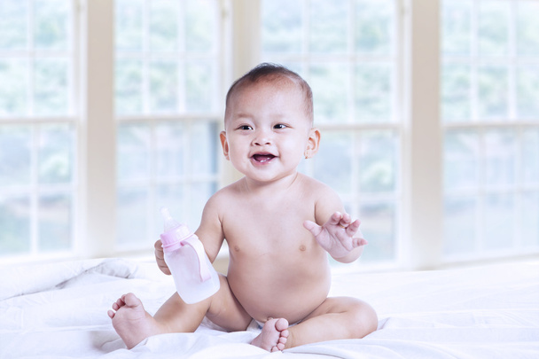 Small baby with milk bottle - Фото, зображення