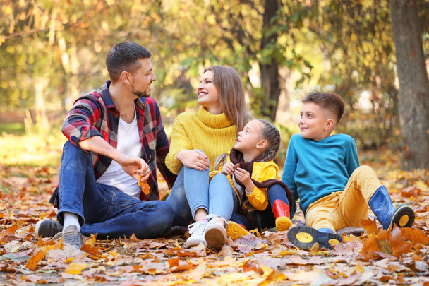 秋の公園で休んでいる幸せな家族 - 写真・画像
