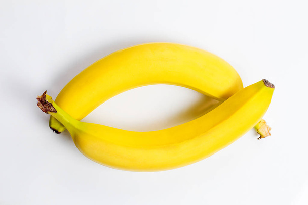 Fresh and tasty yellow bananas for a healthy diet on a white background - Φωτογραφία, εικόνα