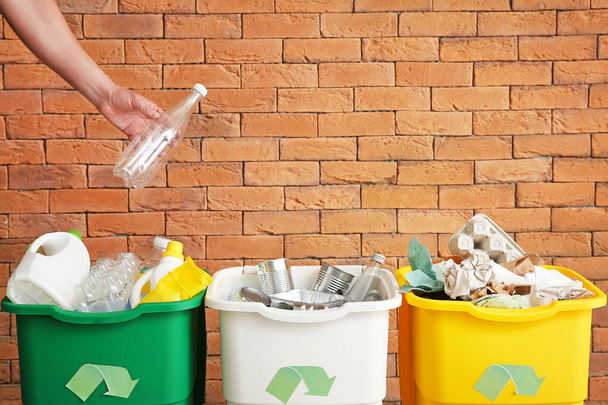 Man throwing garbage into container. Recycling concept - Photo, Image