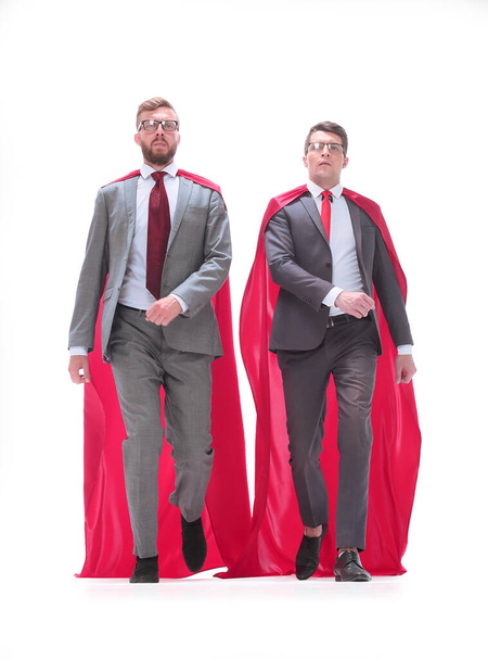 in full growth. two superhero businessman walking together. - Foto, afbeelding
