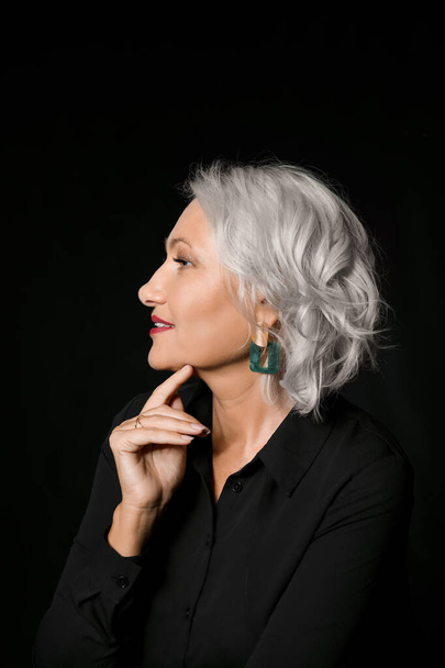 Portrait of stylish mature woman on dark background - Photo, Image