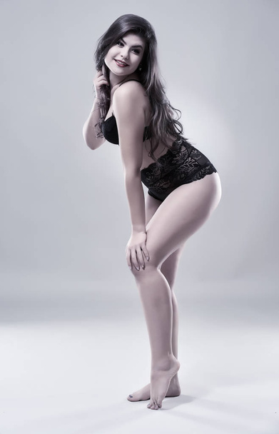 Studio shot of a beautiful latino model on gray background - Фото, изображение