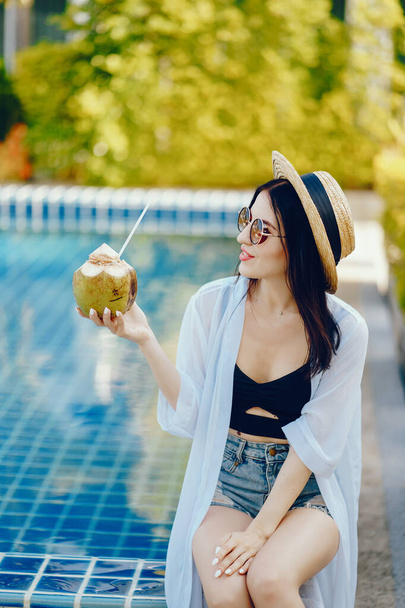 girl drinking fresh juice from a coconut - 写真・画像