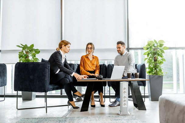 Young couple with financial advisor at the office - Foto, afbeelding