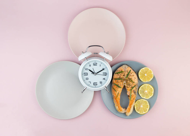 Intermittent fasting concept with empty colorful plates. Time to lose weight , eating control or time to diet concept.Healthy eating food low carb keto ketogenic diet. - Photo, Image