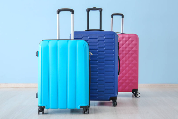 Packed suitcases near color wall. Travel concept - Φωτογραφία, εικόνα