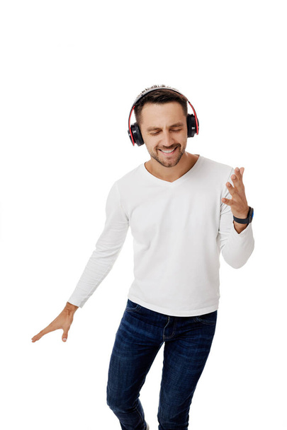 young man in headphones listening to music - Фото, изображение