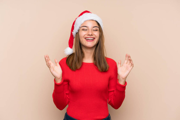 Young girl with christmas hat over isolated background laughing - Fotografie, Obrázek