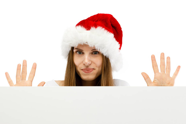 Woman in santa hat posing in studio with copy space background - Foto, Bild