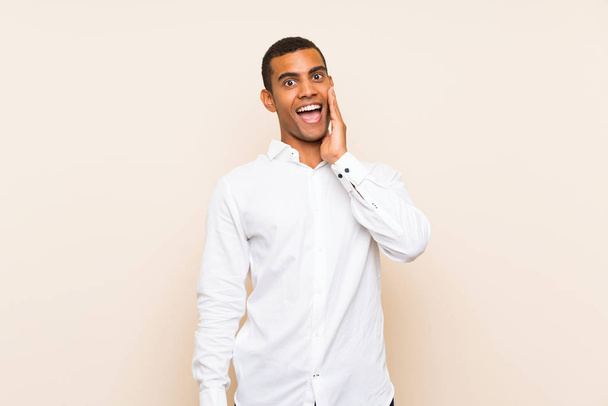 Young handsome brunette man over isolated background with surprise and shocked facial expression - Photo, Image