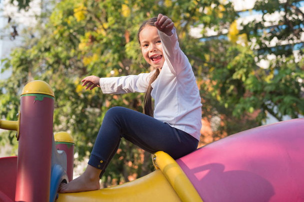 cute little girl playing in kid playground - Fotografie, Obrázek