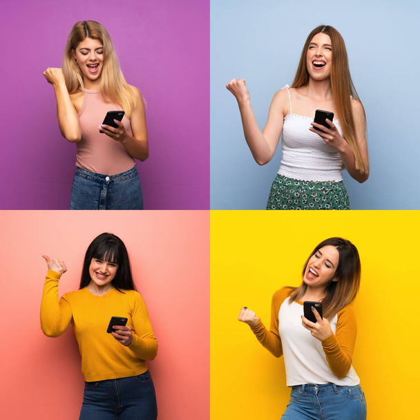 Joukko naisia yli eristetty värikkäitä taustoja puhelimen voittoasennossa
 - Valokuva, kuva