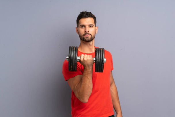 Young sport man making weightlifting - Фото, изображение