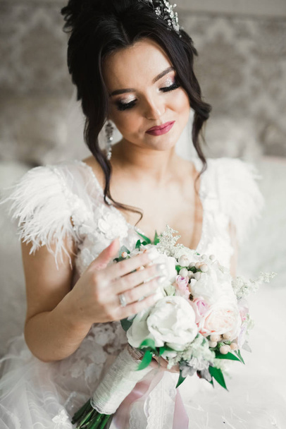 Bride holding big and beautiful wedding bouquet with flowers - Фото, изображение