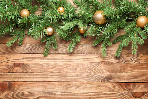 Beautiful Christmas tree branches with decor on wooden background - Fotografie, Obrázek