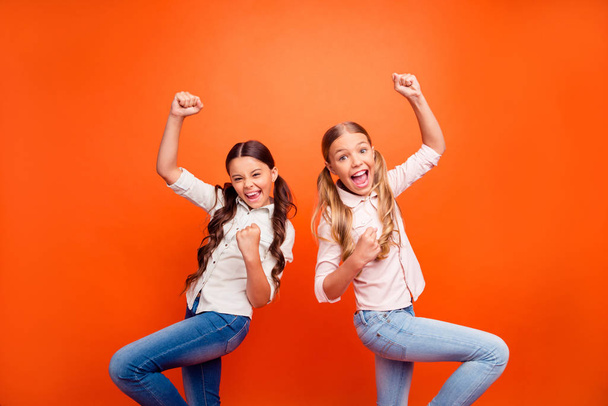Portrait of crazy ecstatic sports fan kids watch team play celebrate victory scream yeah raise fists wear modern casual style clothing isolated over bright color background - Photo, image