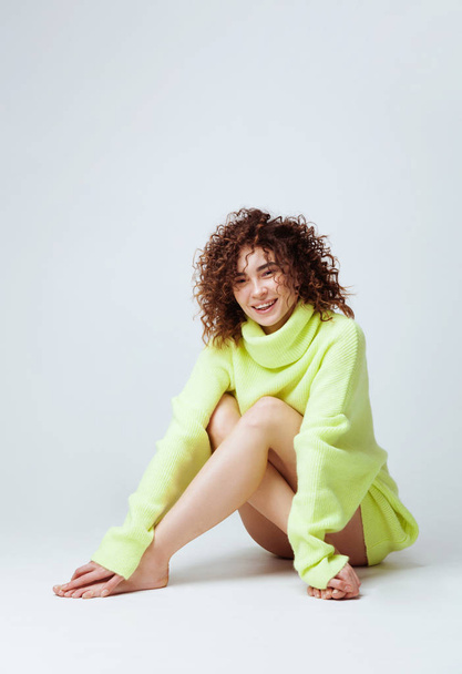 Portrait of lovely woman with curly hair in warm cozy sweater  - Fotoğraf, Görsel