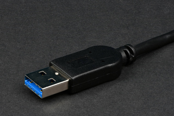 Closeup USB cable isolated on black. - Photo, Image