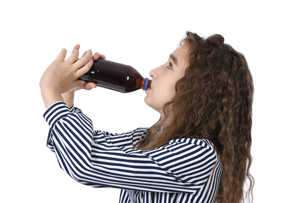 Child drinking Cola from bottle. - 写真・画像