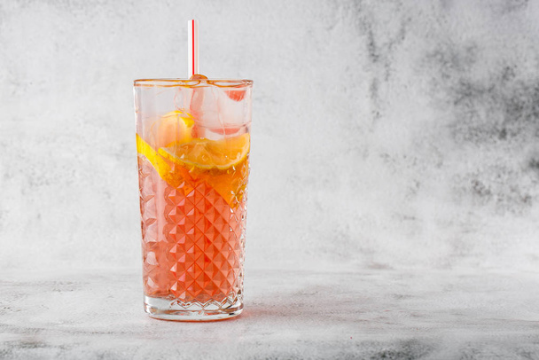 Two glass with lemonade and orange cocktail with lemon and orange, cold refreshing drink or beverage with ice on bright marble background. Overhead view, copy space. Advertising for cafe menu. Horizon - Фото, изображение