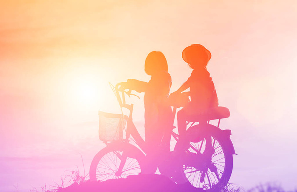 silhouette of a happy children and happy time sunset - Фото, зображення