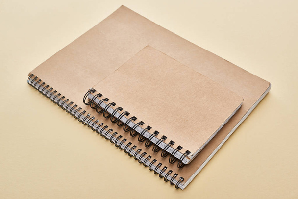 two paper blank notebooks on beige background - Фото, изображение