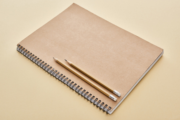 paper blank notebook with pencils on beige background - Photo, Image