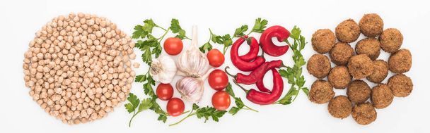 top view of chickpea, garlic, cherry tomatoes, parsley, chili pepper and falafel on white background, panoramic shot - Photo, Image