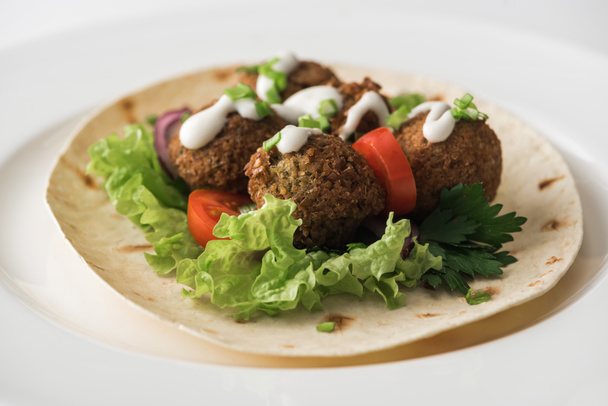 close up view of falafel with sauce on pita with vegetables in white plate - Photo, Image