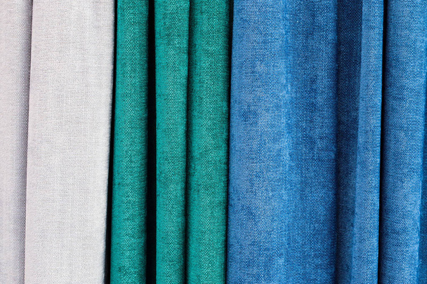 Close up view on folded cloth and fabric textures in different colors - Fotografie, Obrázek