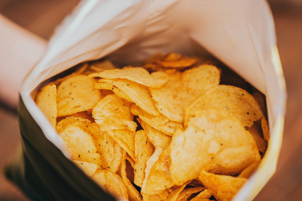 close up view of delicious crispy potato chips in package - Photo, Image